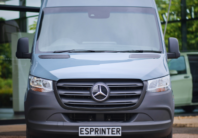 A dusty blue Mercedes-Benz eSprinter